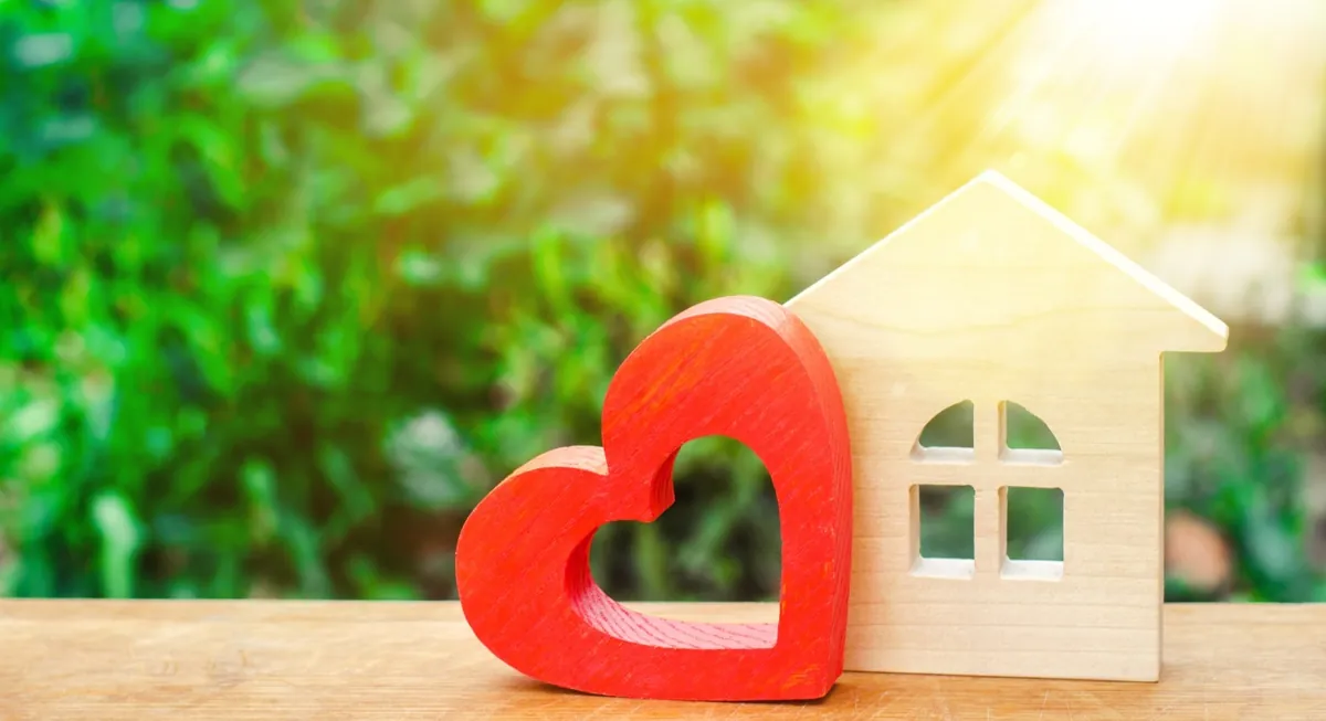 Wooden heart beside a model home