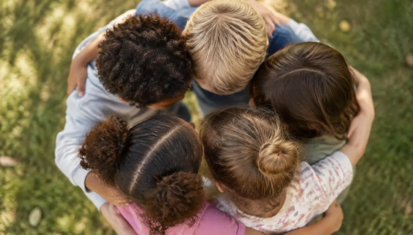 Children standing together in a supportive circle